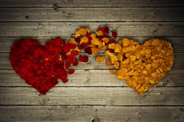 A wooden table with red and yellow hearts cut out of it.