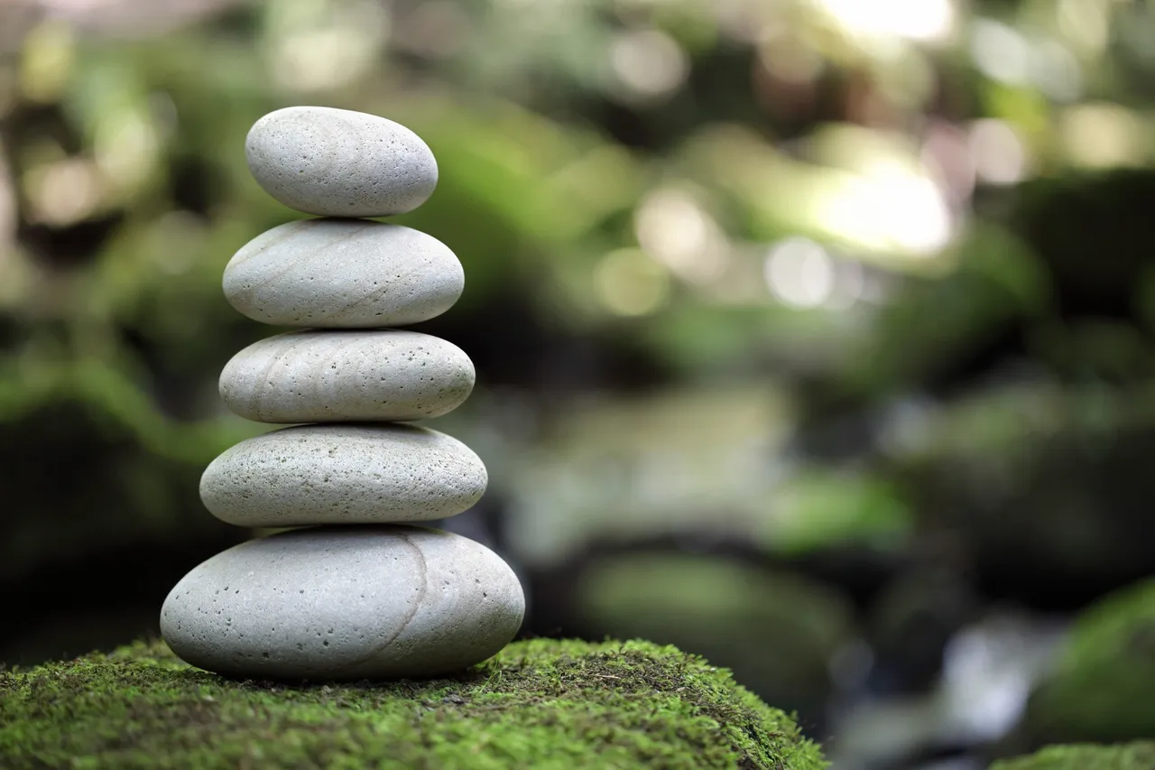 A stack of rocks on top of moss.